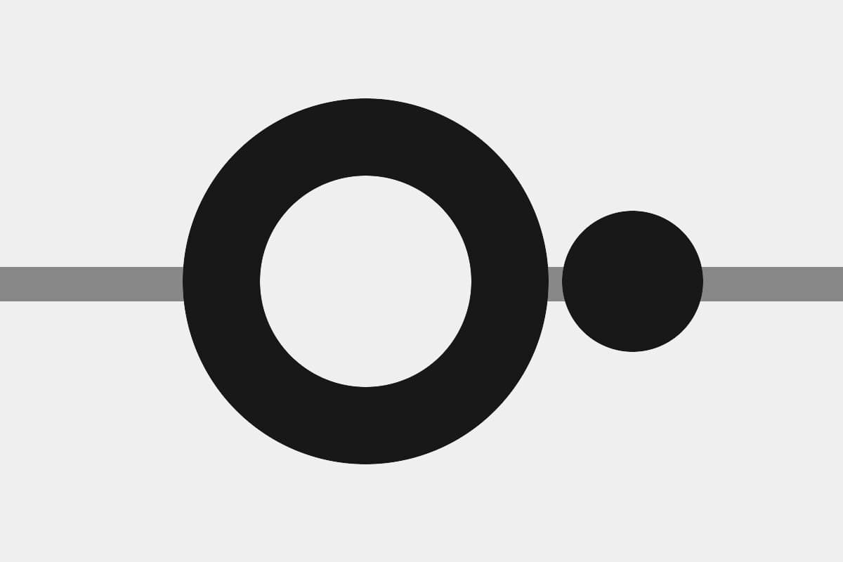 Abstract grayscale composition of a ring and a disc on a horizontal rule.